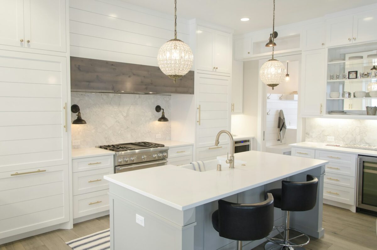 A bright kitchen with white cabinets and natural light
