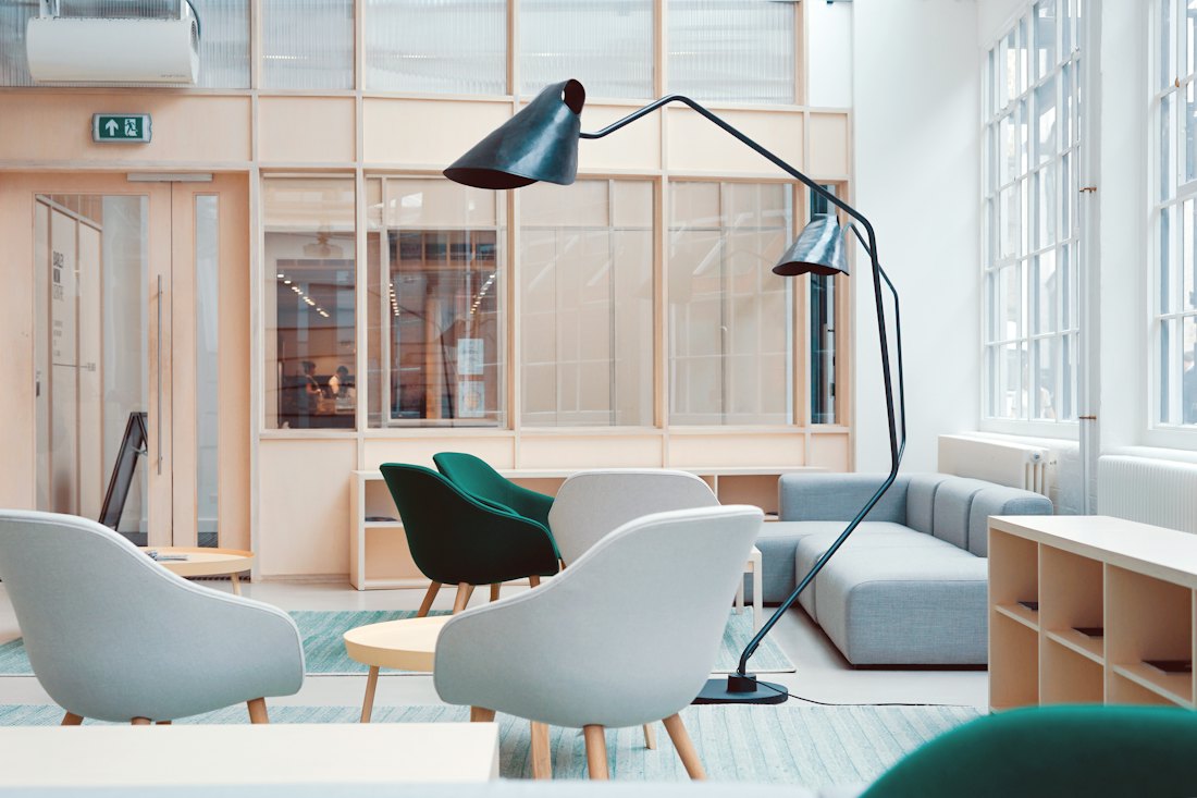 A light, tidy office with desks and large windows